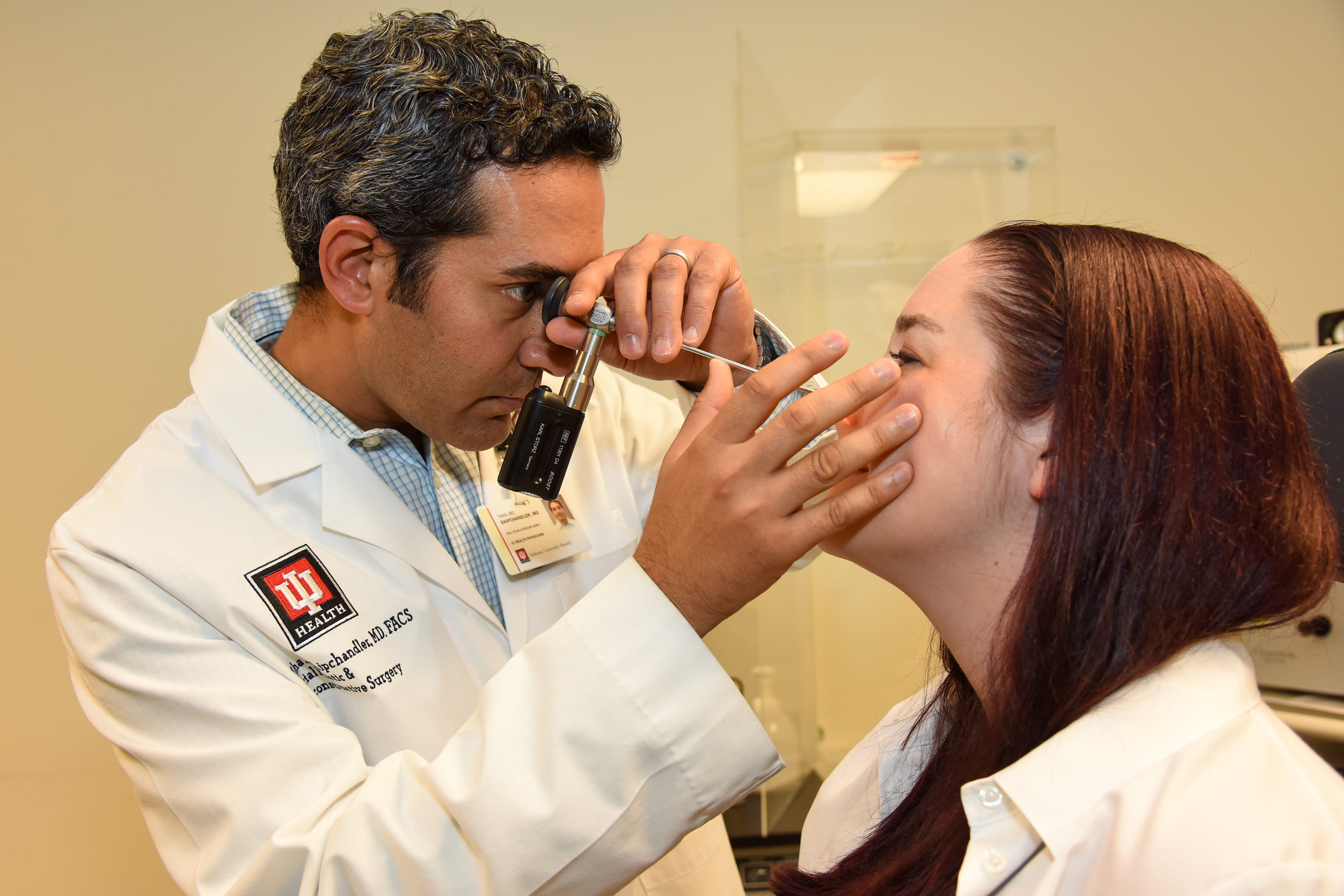 Dr. Shipchandler examines a patient in the clinic