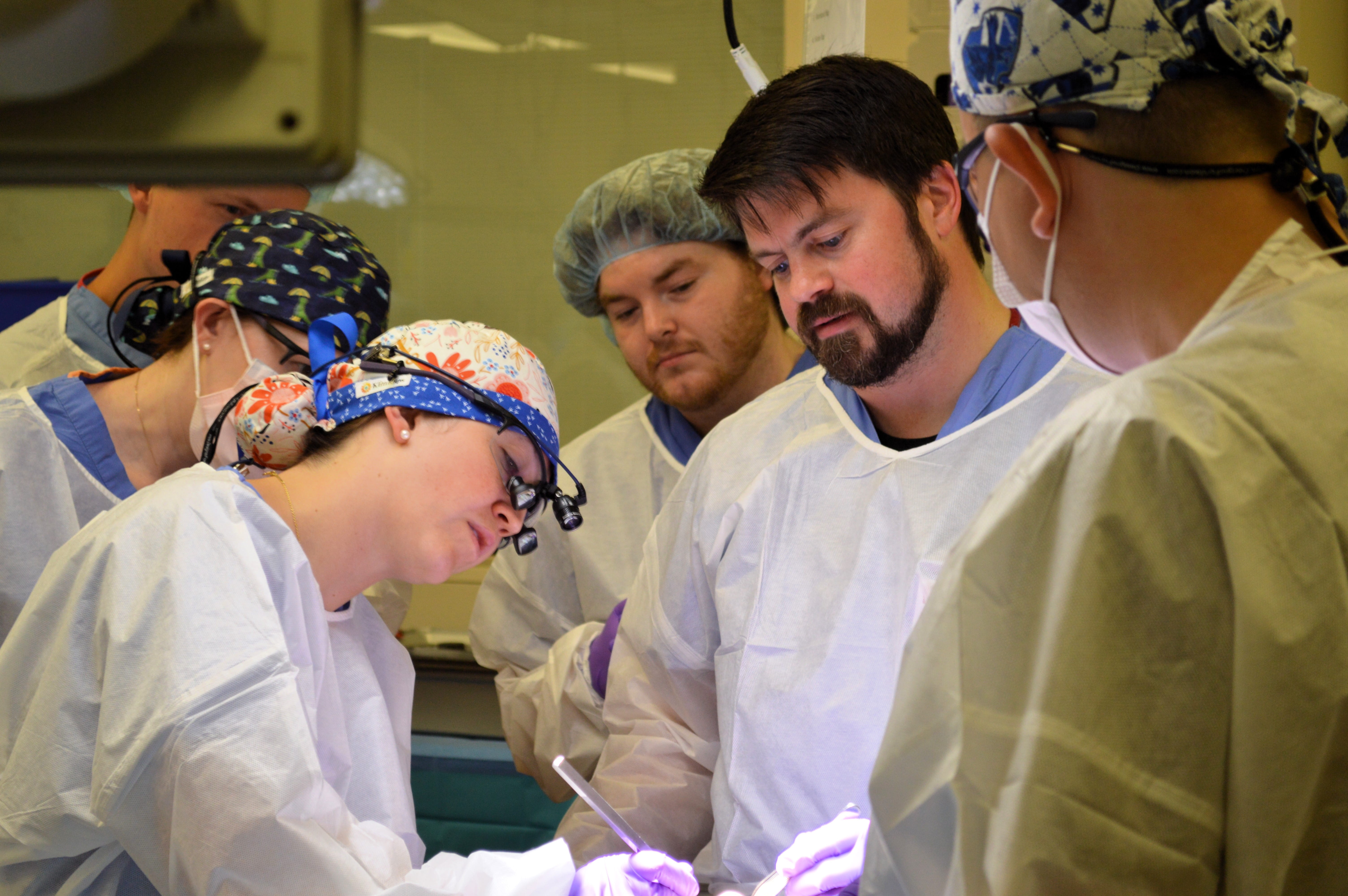 physician and trainees in sim lab