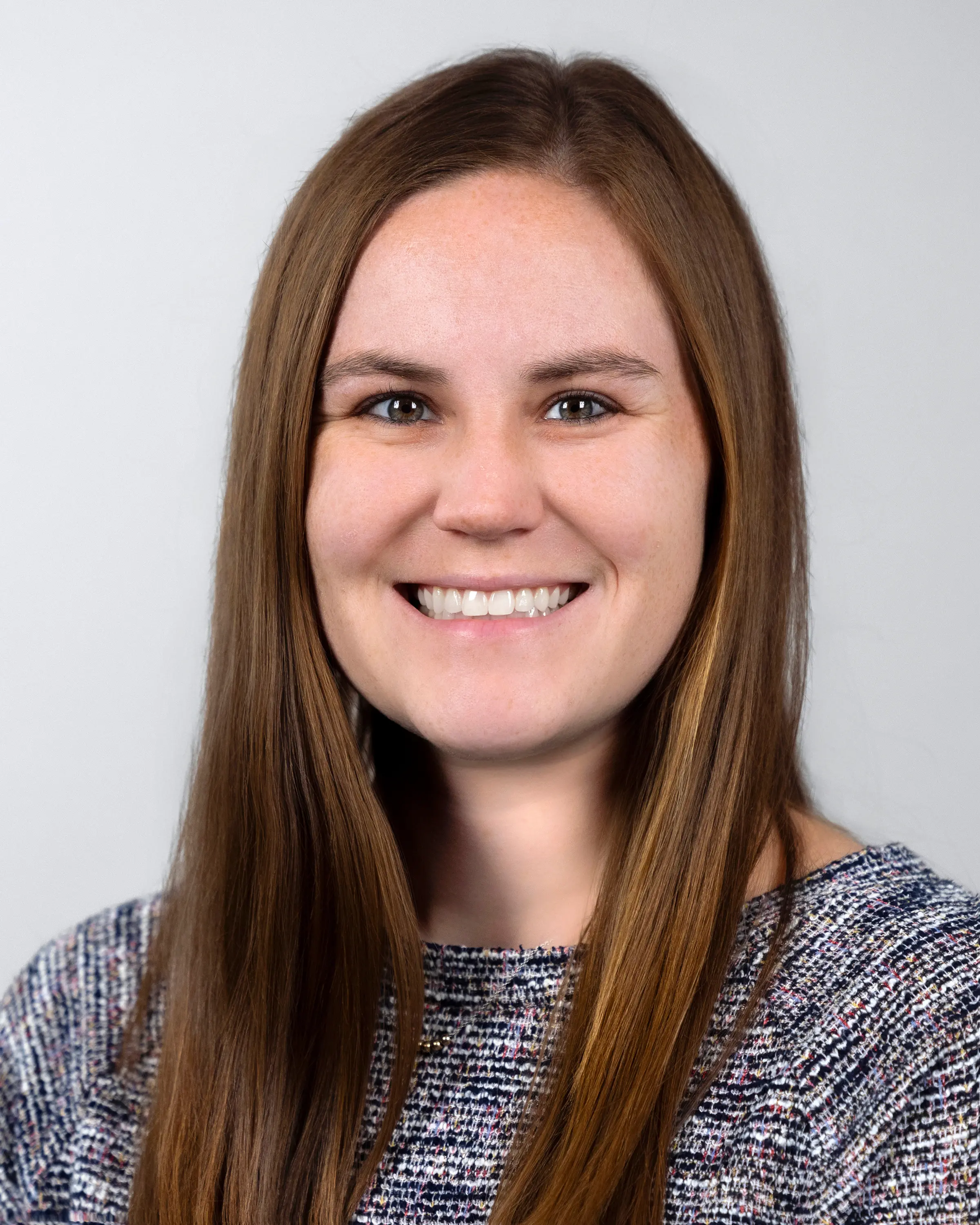 Person in professional attire smiling at camera