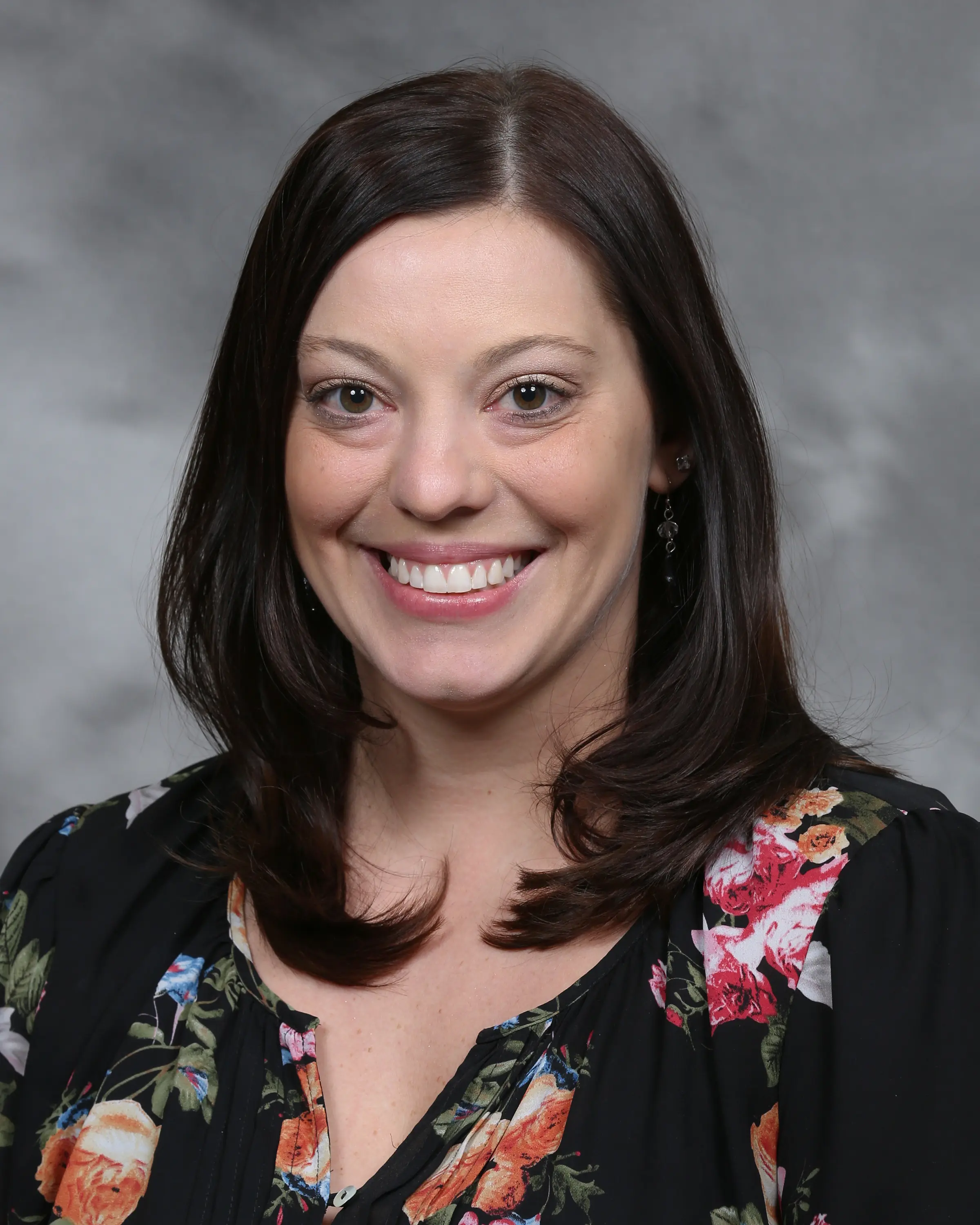 Person in professional attire smiling at camera