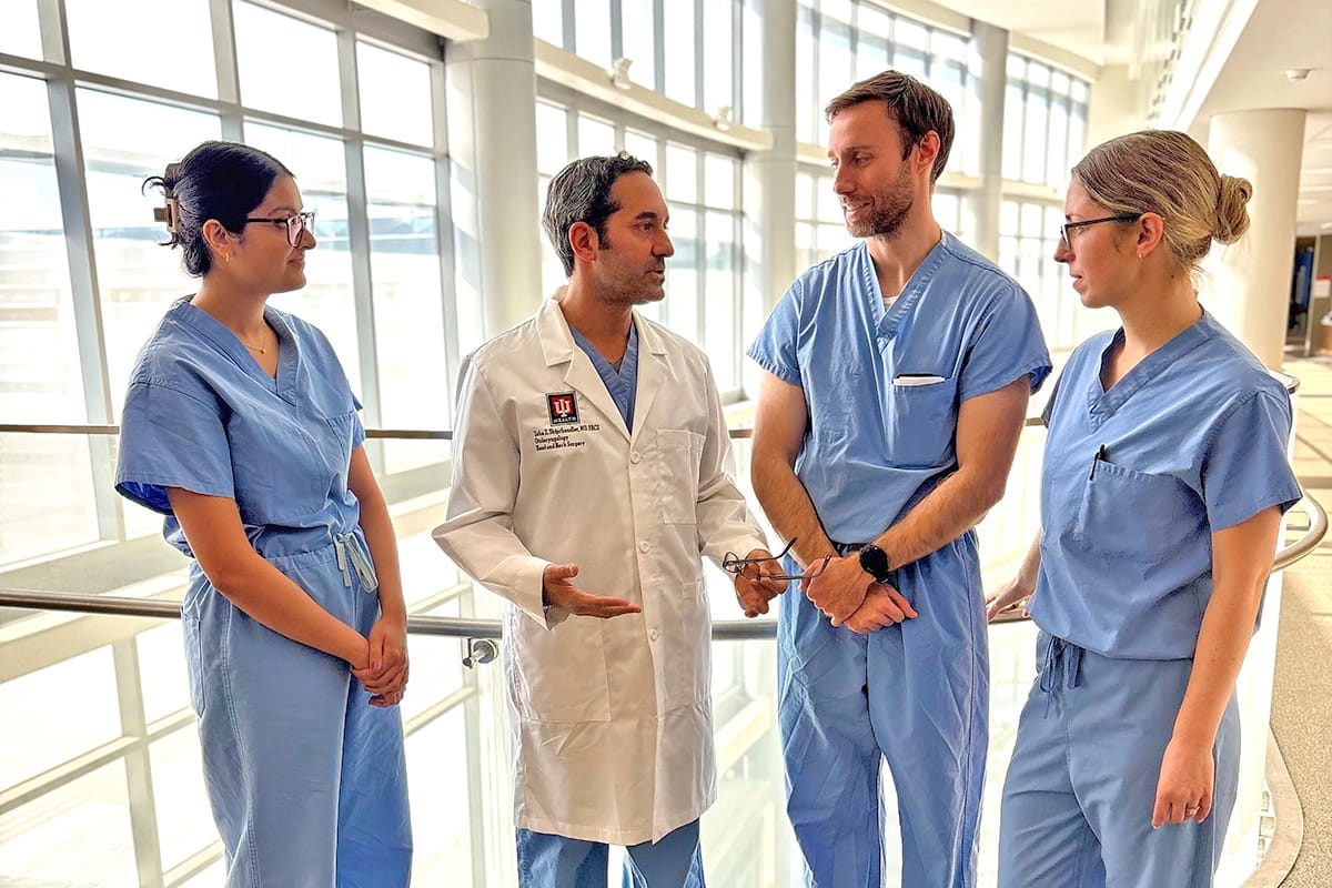 Physicians and trainees wearing scrubs in lobby