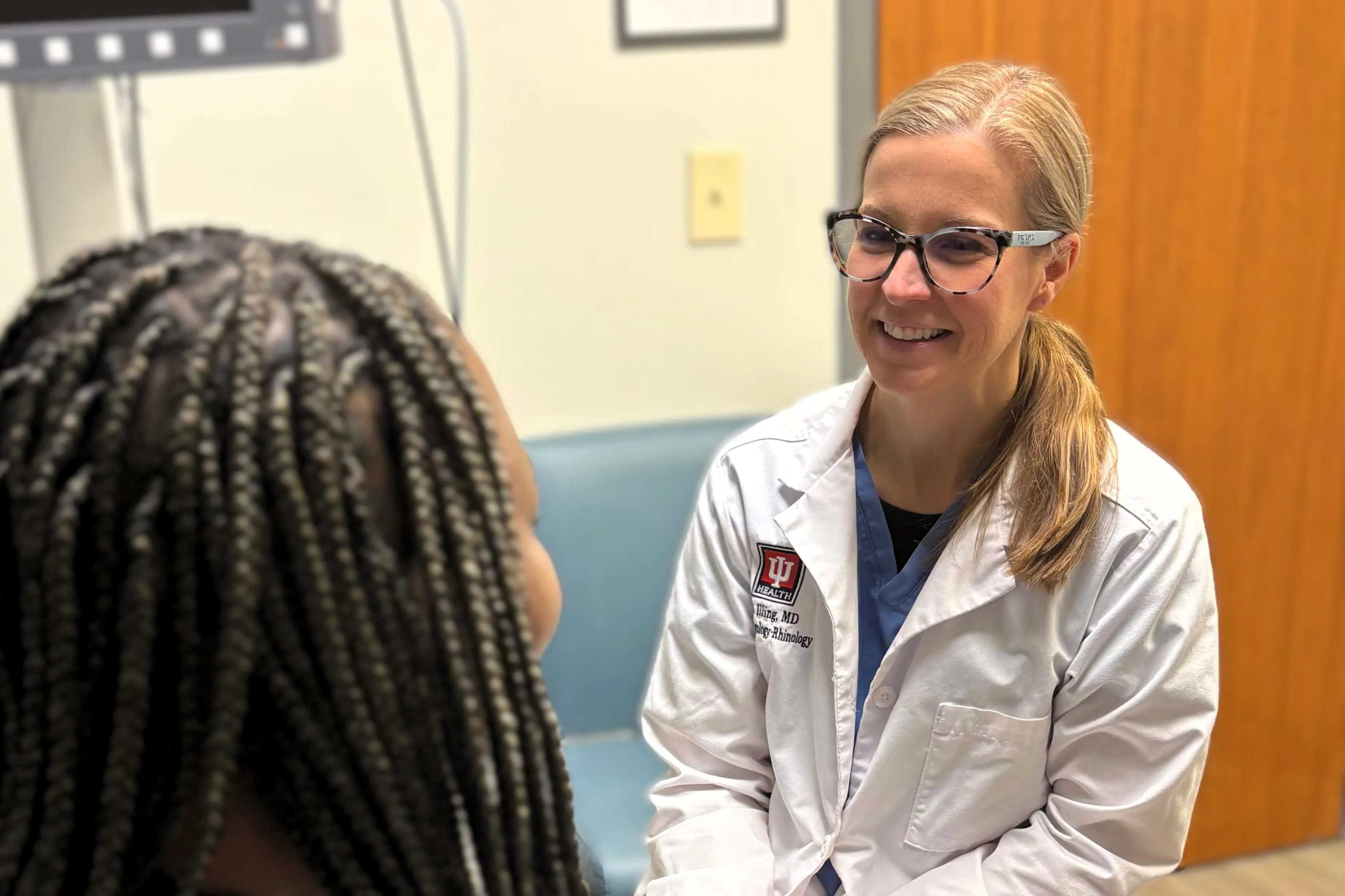 Physician in white coat consulting with patient