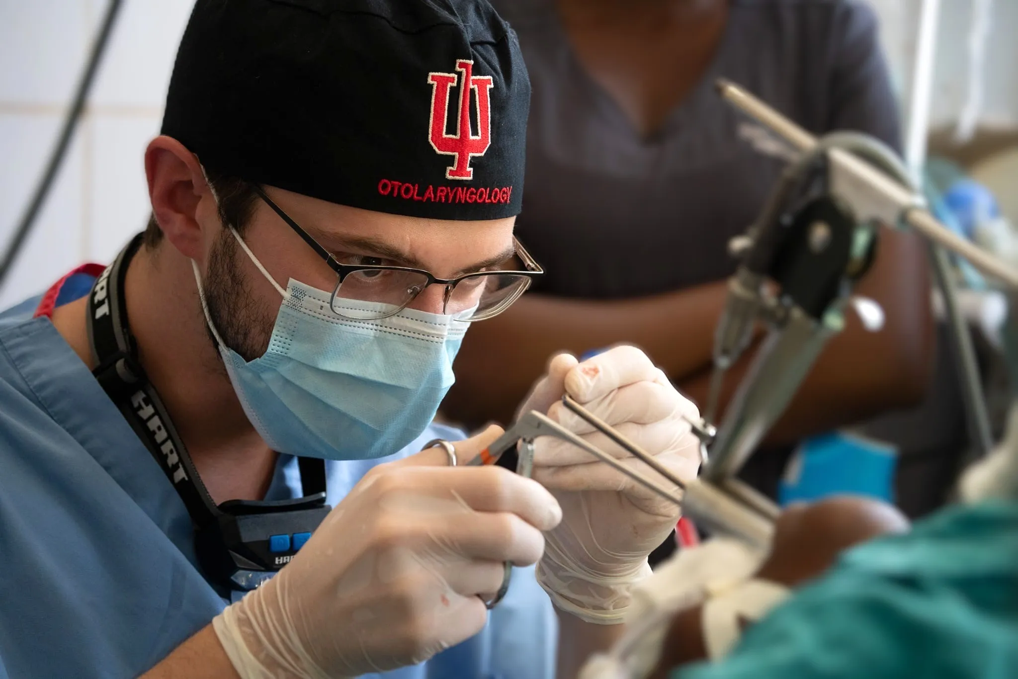 Physician in scrubs performing sinus surgery