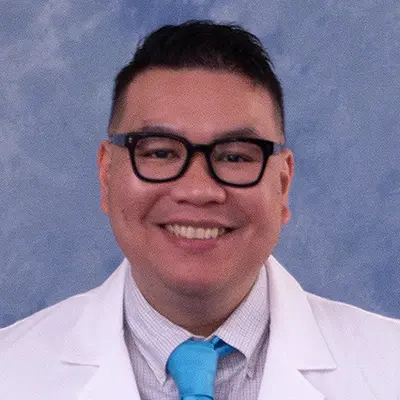 Joel in a white lab coat