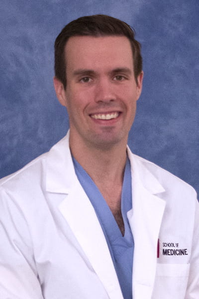 andrew tharpe in a white lab coat