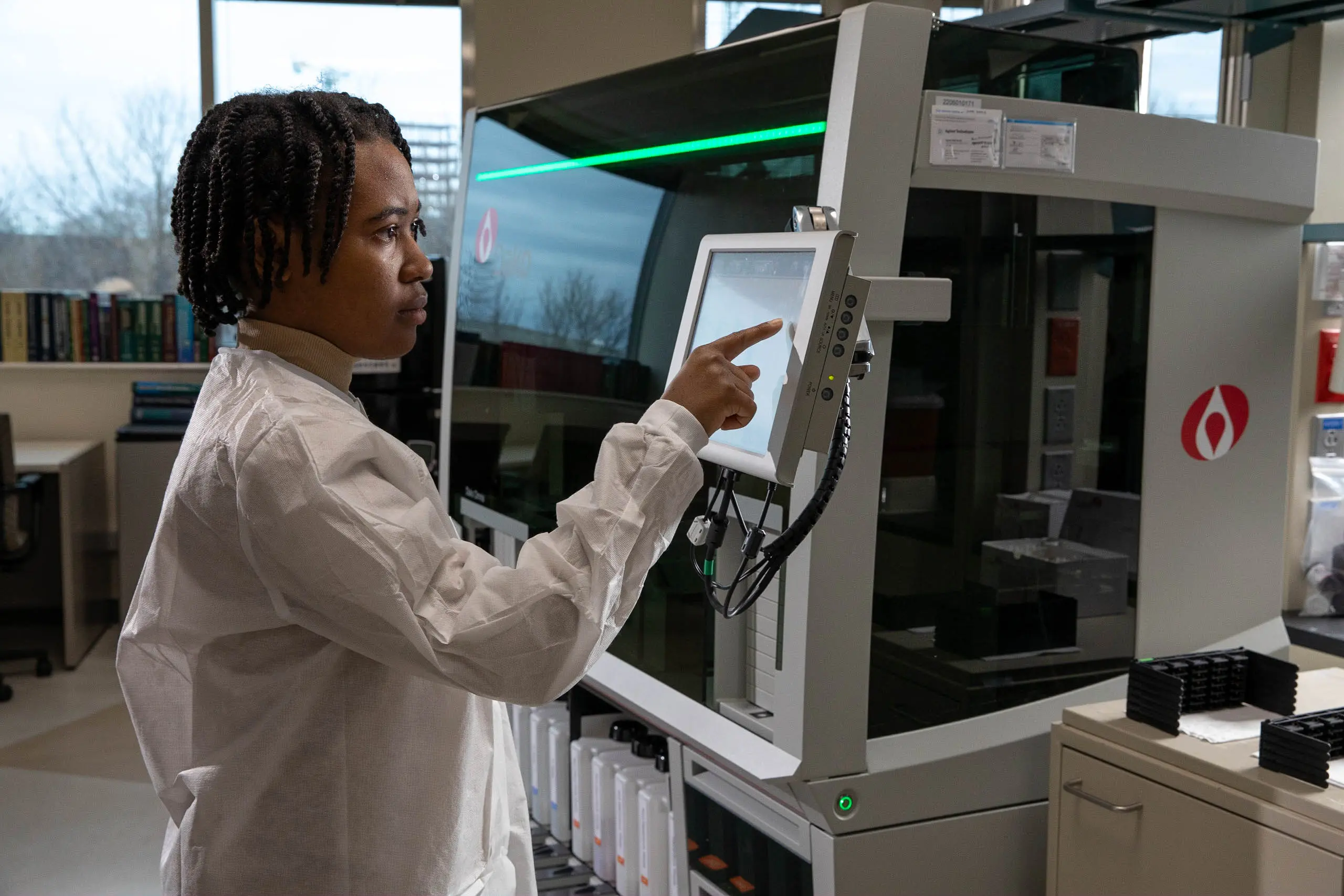 a researcher in a white coat prepares a sample in the lab