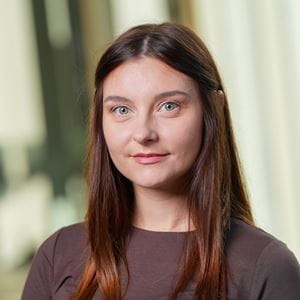 Sylwia wearing a dark shirt with straight long brown hair