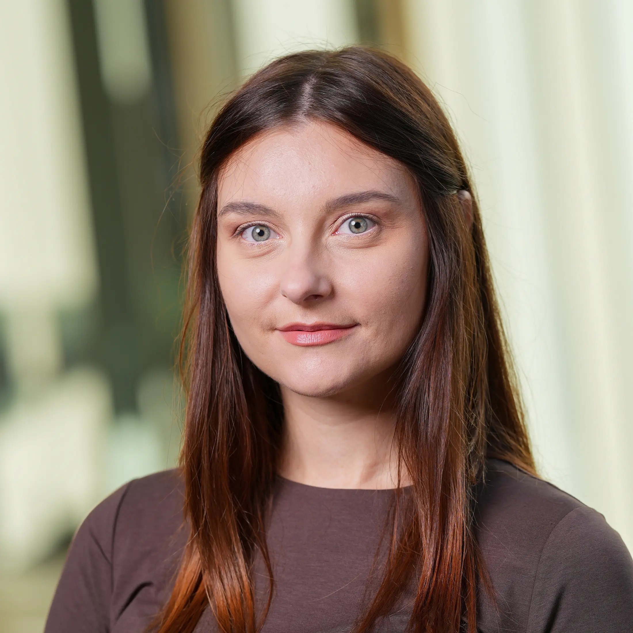 Sylwia wearing a dark shirt with straight long brown hair