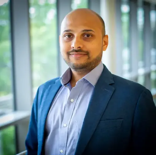 Dr. Shiradkar wearing a dark jacket and button up shirt