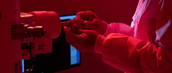 MD Pathology doctors hands using lab equipment in a red roon