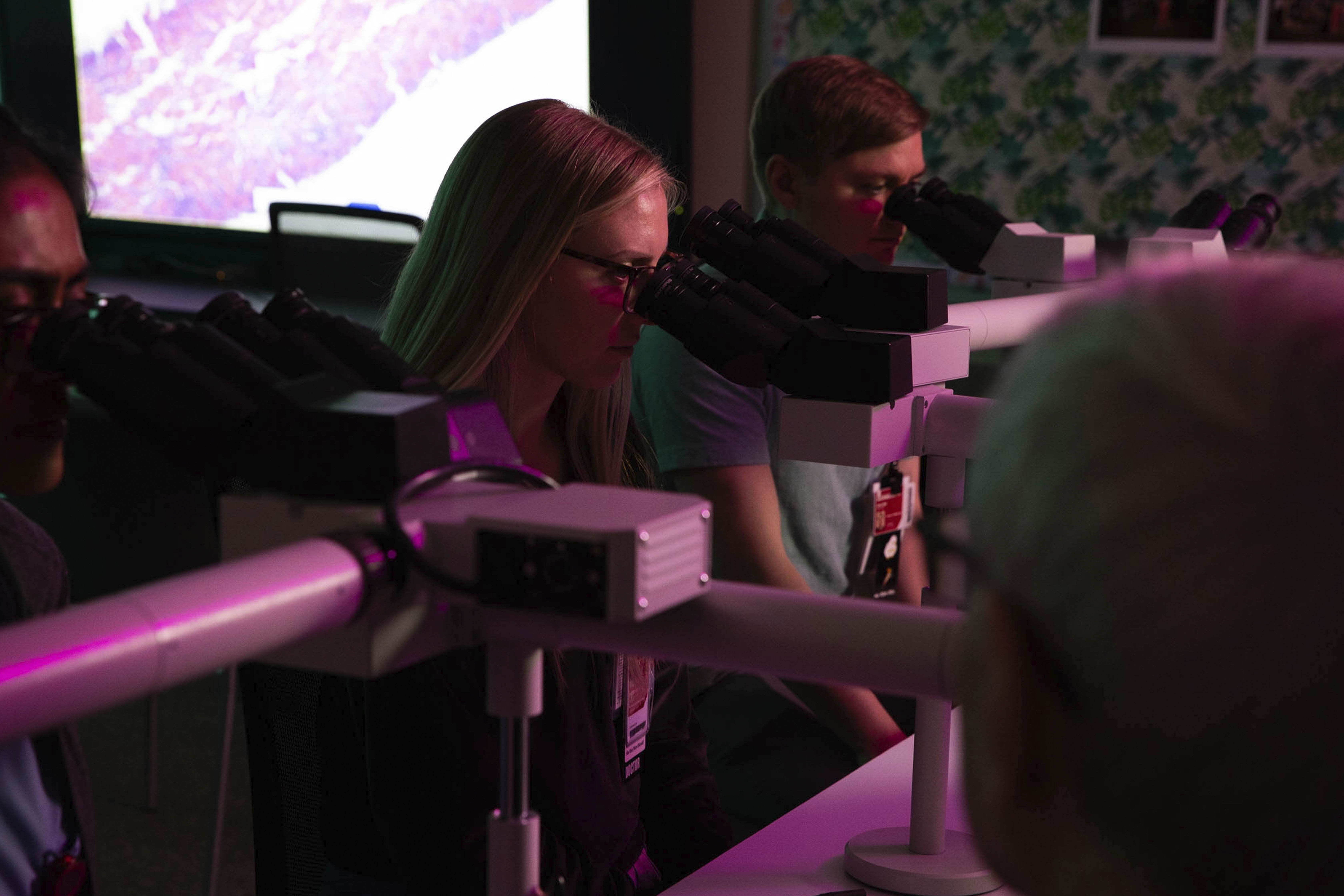 MD Pathology Students looking at microscopes