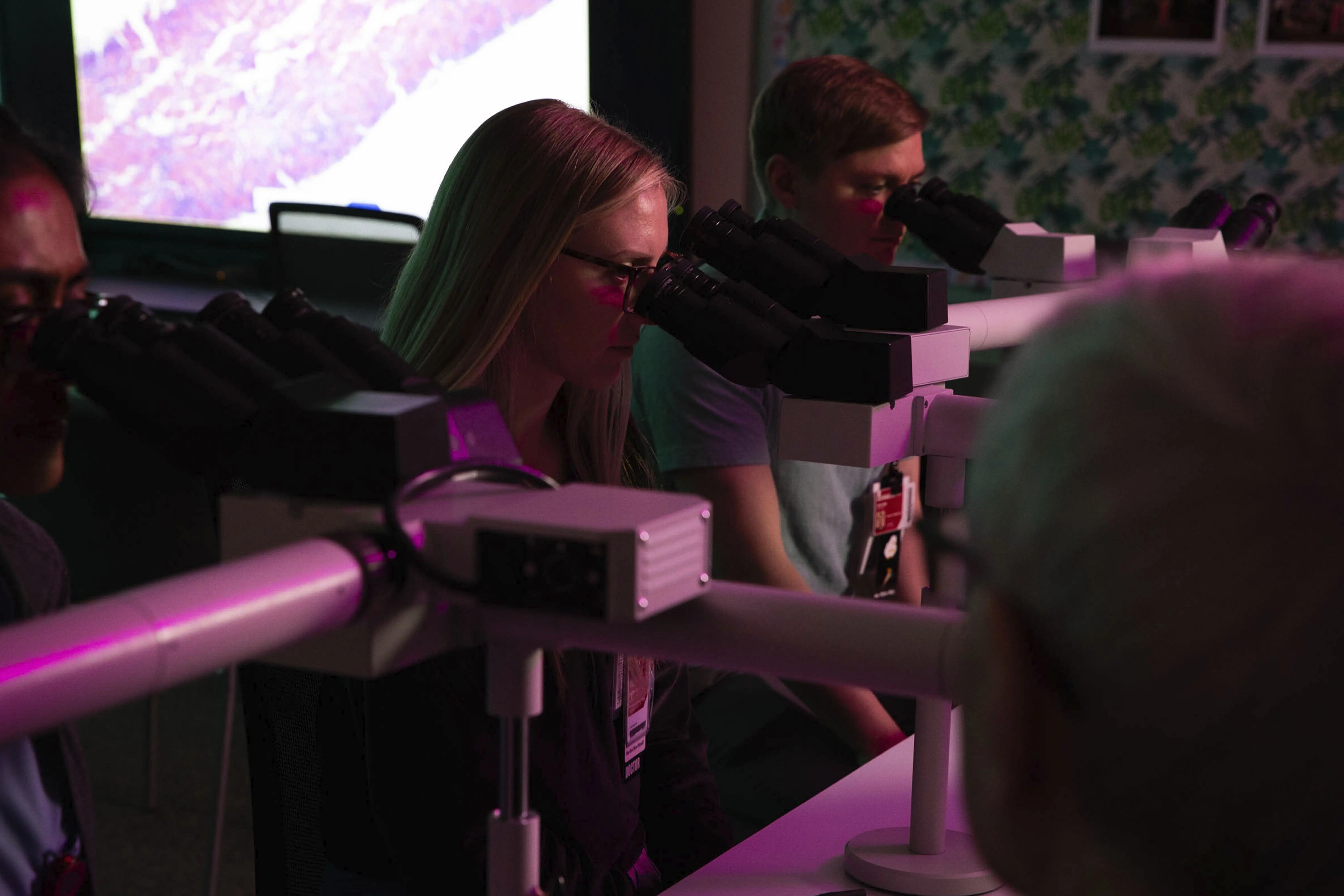 MD Pathology Students looking at microscopes