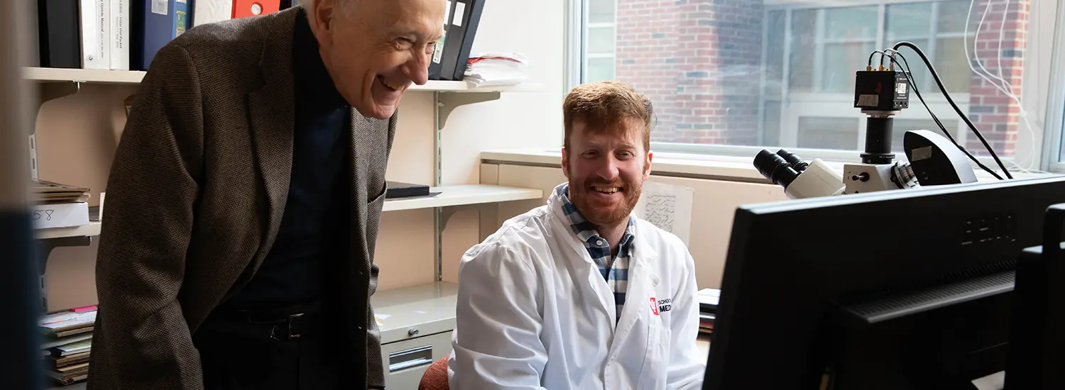 Two IU doctors looking at a computer