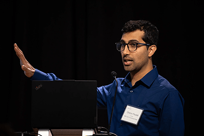 chetan poudel speaks at a podium