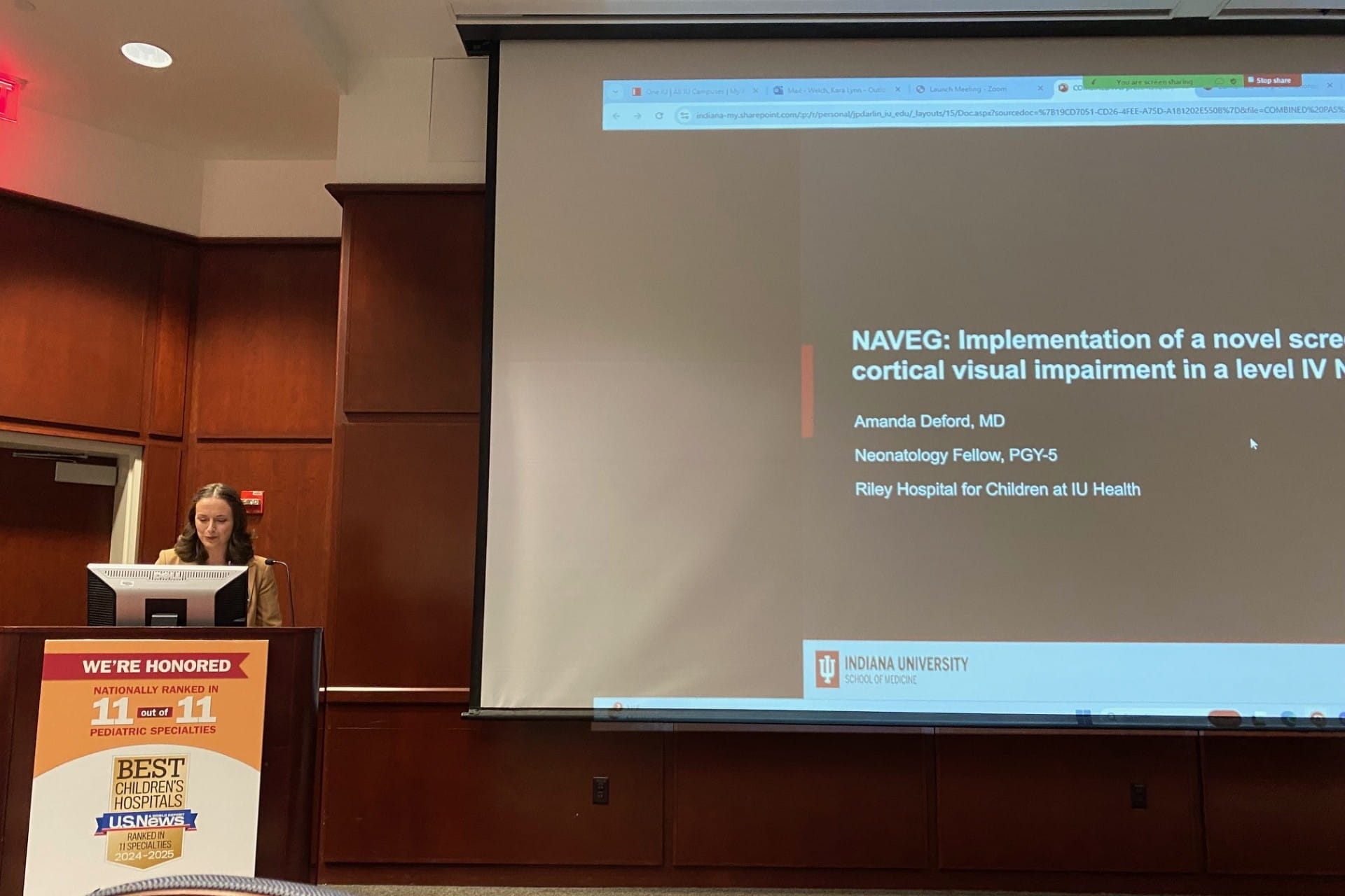 Amanda Deford, MD presenting her work at Pediatrics Grand Rounds at IU Woman presenting her work at a conference