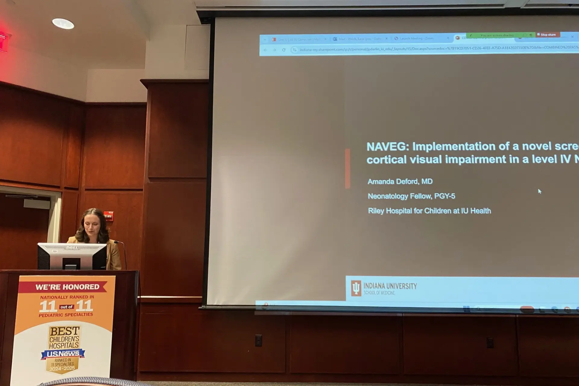 Woman presenting her work at a conference
