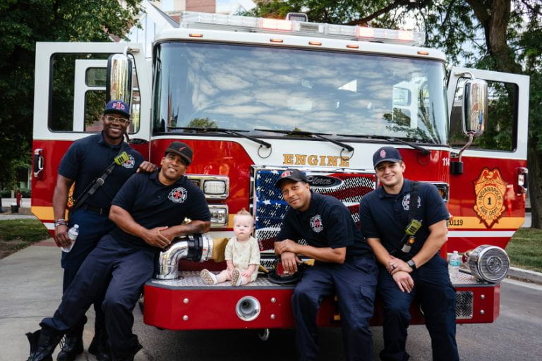 Indianapolis Fire Department crew and former Cardiovascular ICU patient, Hendrix Fox, pose together on a firetruck at the ninth annual Pediatric Critical Care Walk-a-Thon in 2024. Photo courtesy of Riley Children’s Health.