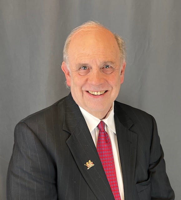 wade clapp wearing a black suit and red tie.