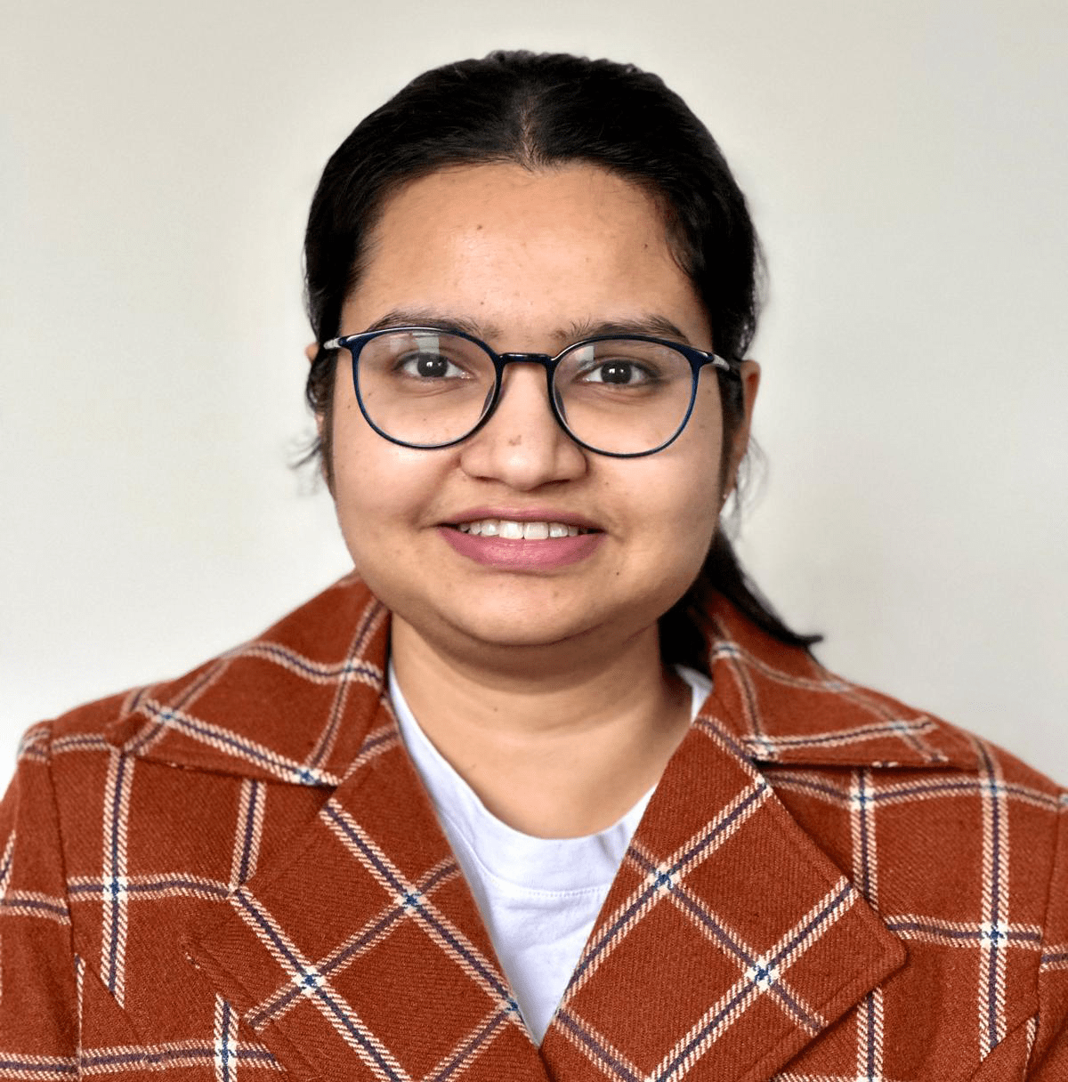 Headshot of woman in plaid jacket