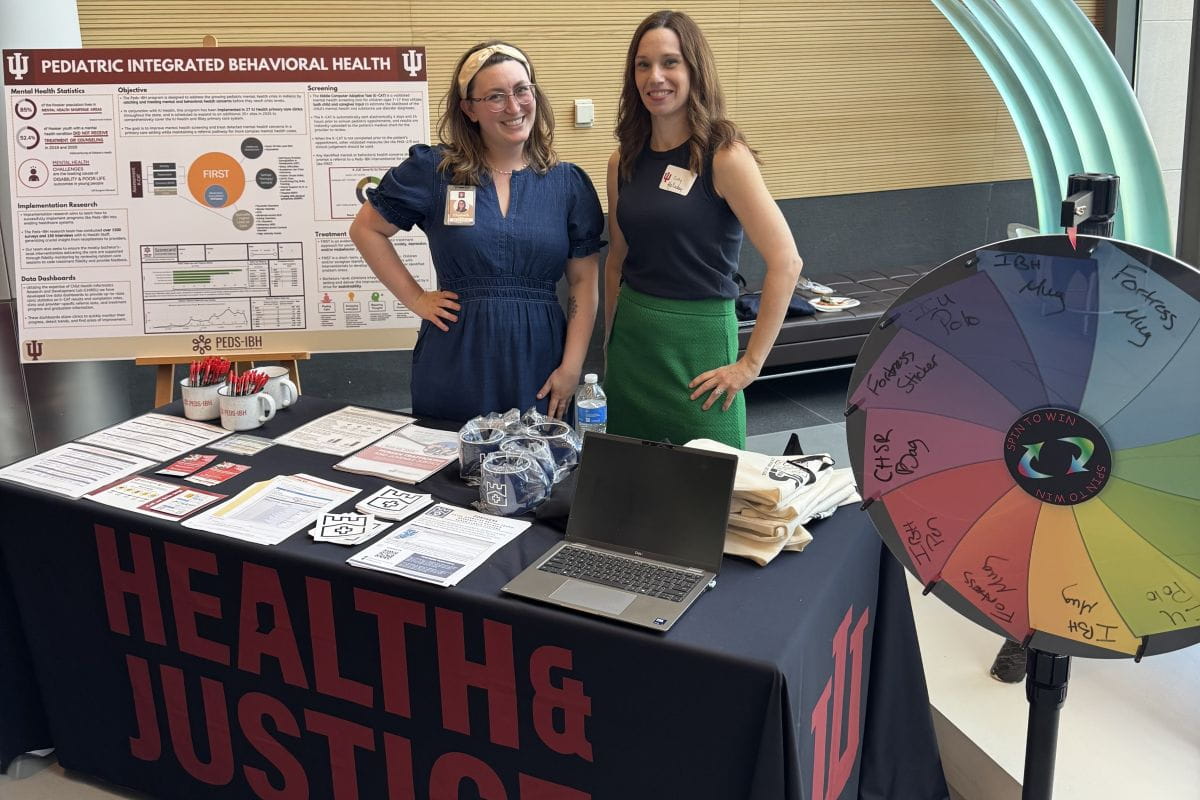 Two lab members at a tabling event