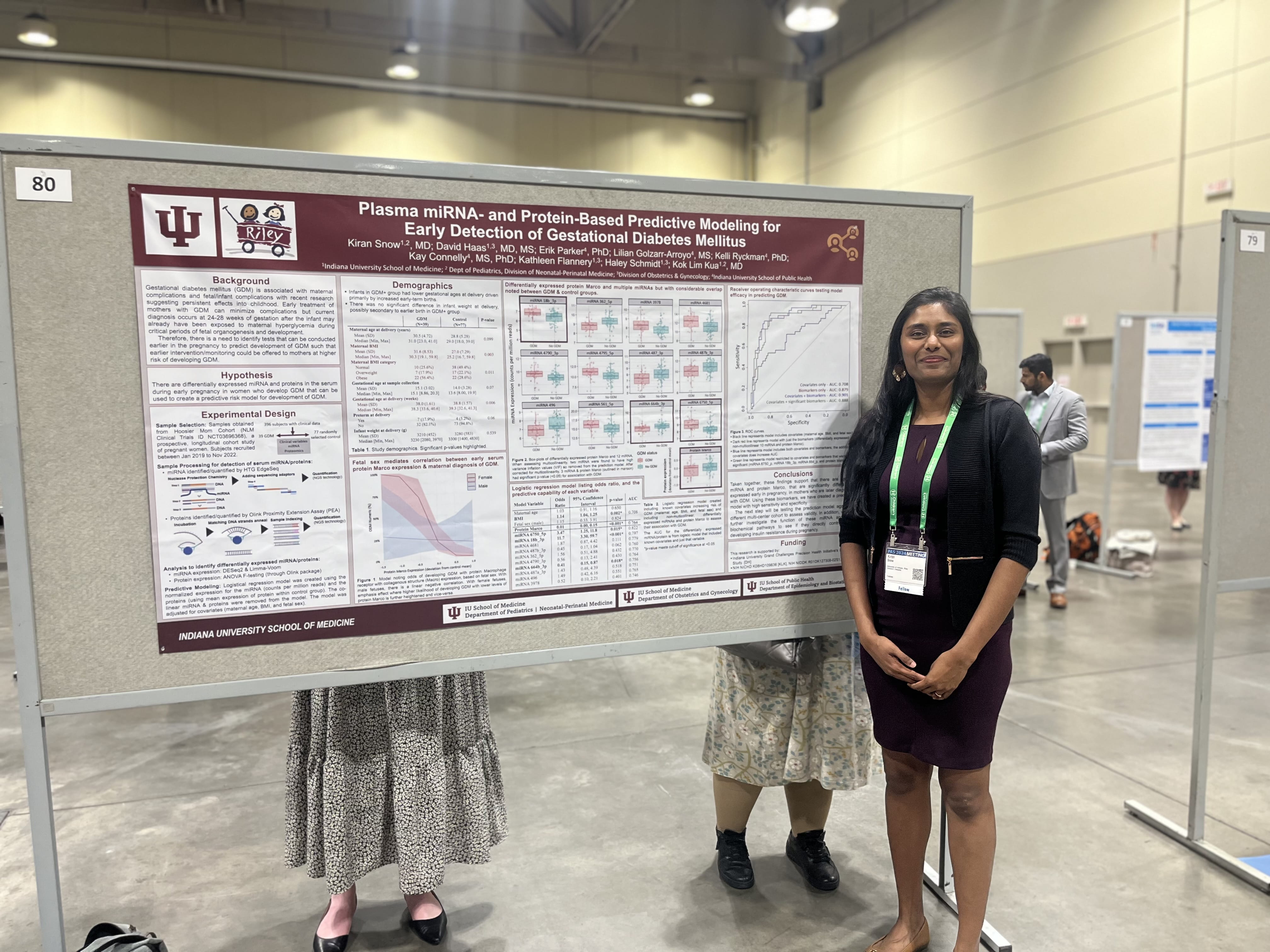 Woman presenting poster at a conference