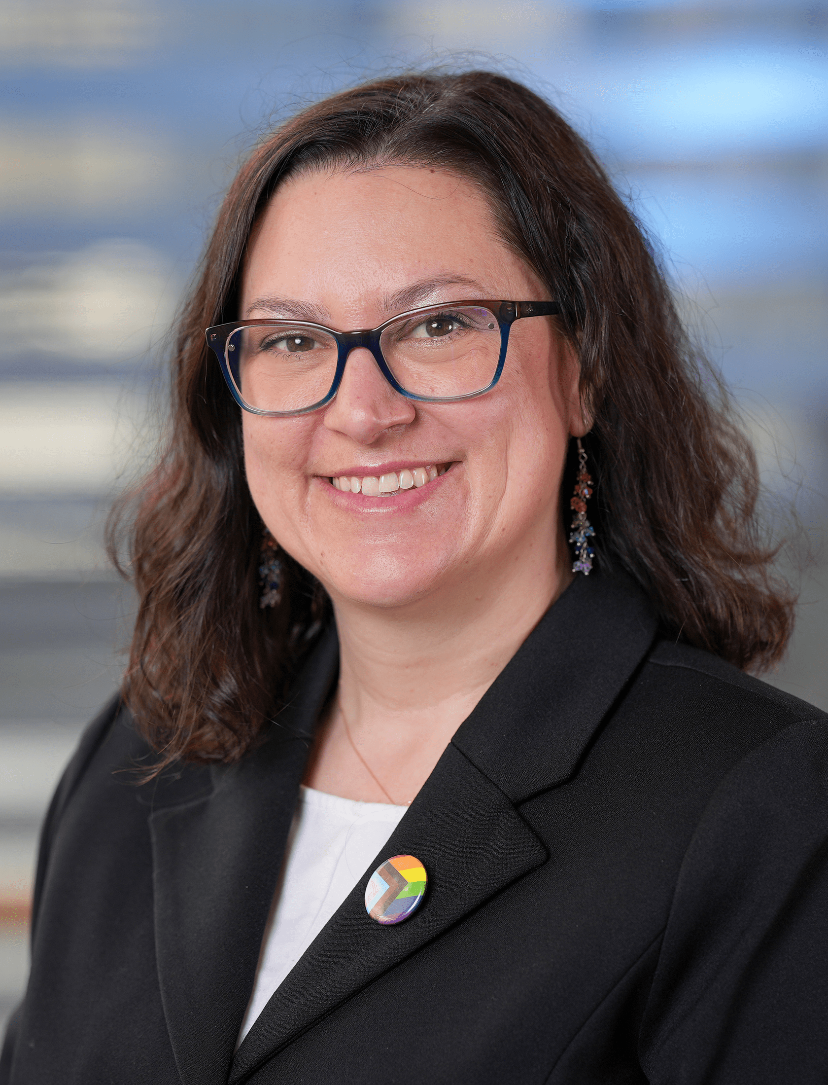 Headshot of a woman in glasses and a suit jacket