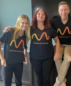 Mothers On The Rise team photo wearing t-shirts with their logo