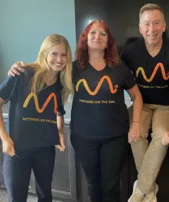 Mothers On The Rise team photo wearing t-shirts with their logo