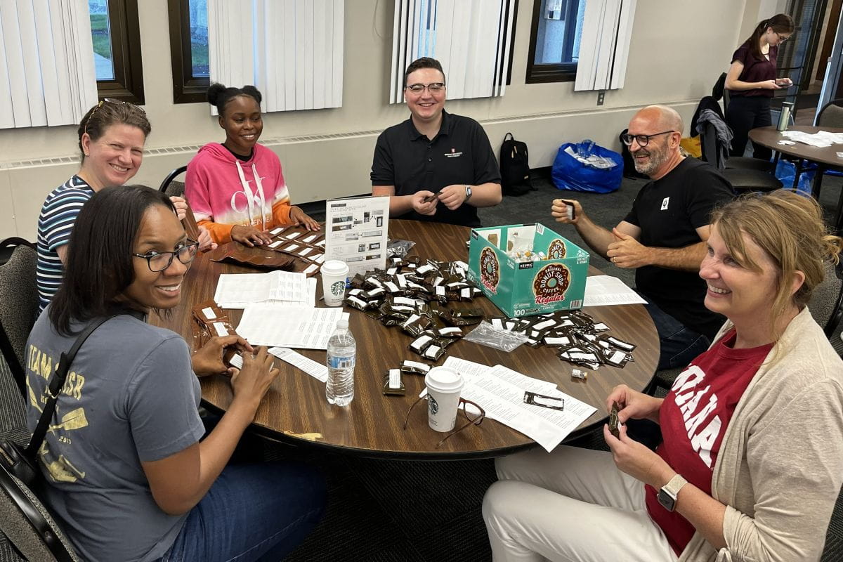 Overdose Lifeline team members work together at a round table