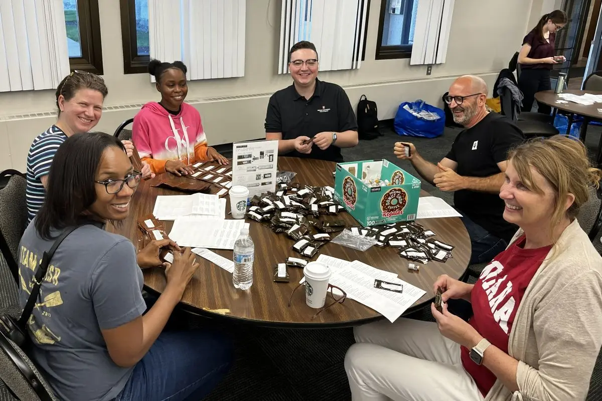 Overdose Lifeline team members work together at a round table