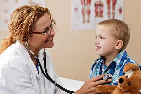 A pediatric patient being seen by a doctor