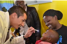 A Global Health doctor seeing a patient and family