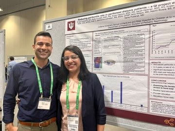 Fellows Shrea and Evan with their research poster
