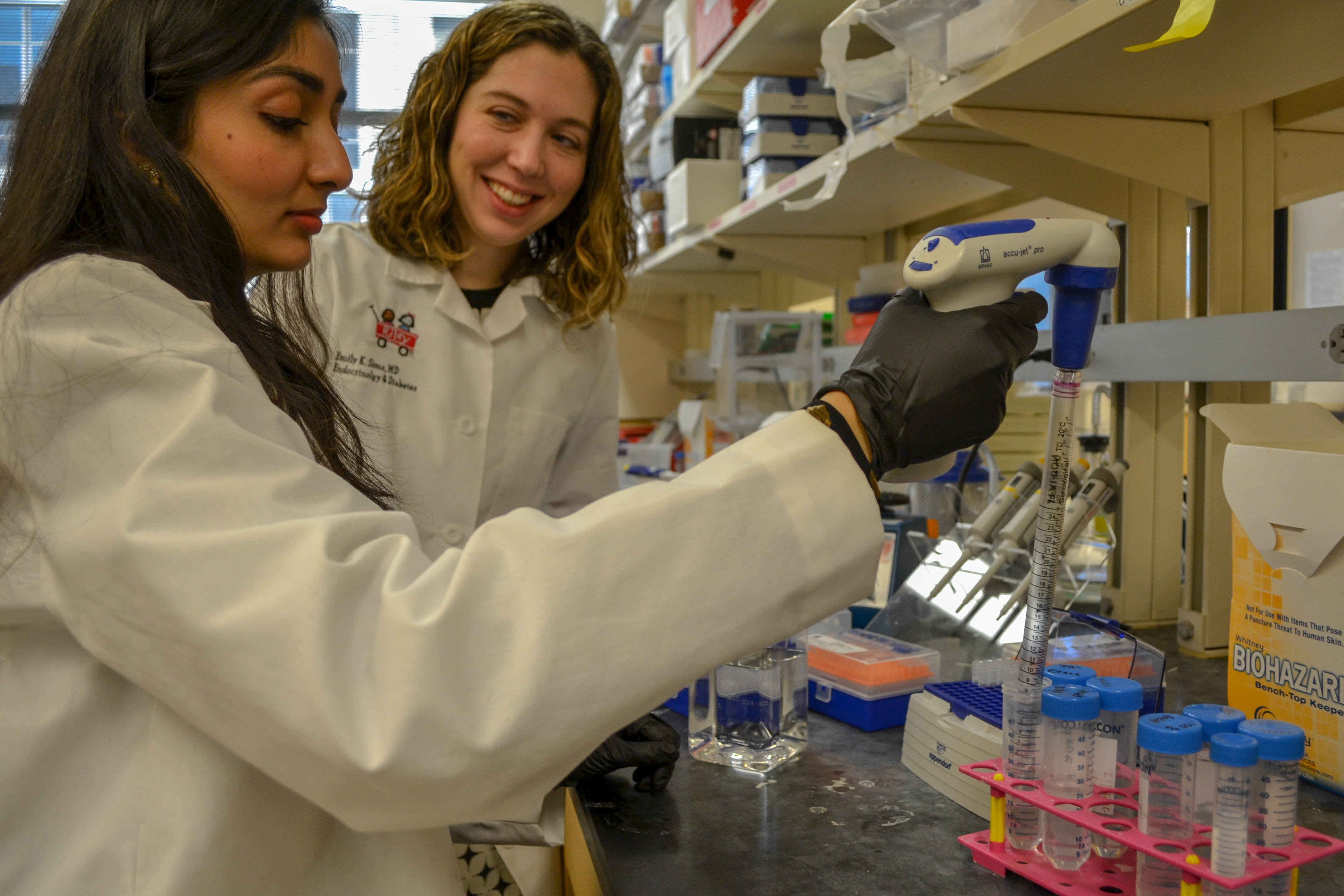 Emily Sims, MD, supervises a student in her lab