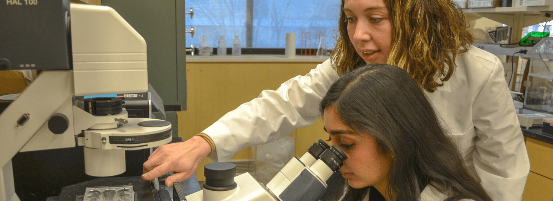 Emily Sims, MD, works with a student in her lab