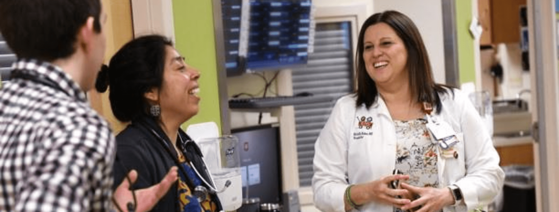 Richelle Baker, MD, works with residents and fellows while rounding on the inpatient units