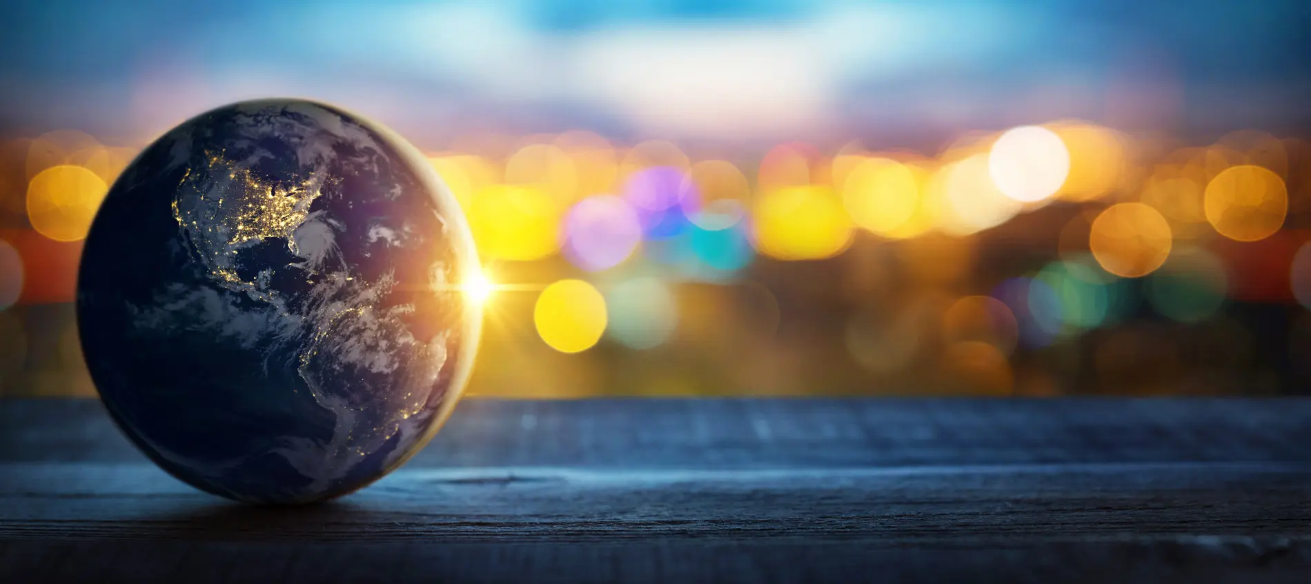 Miniature global globe against a city background.