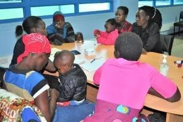 Adults and children gathered around a table.
