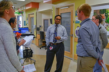 Physicians and Fellows talking in the hall of a clinic