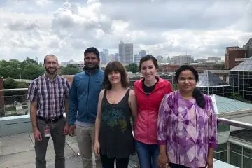 Five members of the Schmidt lab posing in front of the Indianapolis skyline
