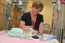 A provider is examining a neonate in a hospital 