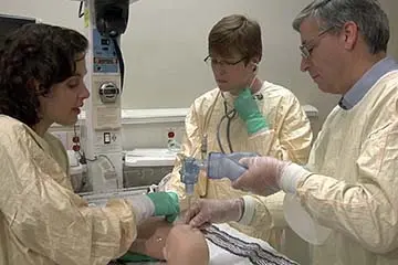 Three providers doing simulation on simulated neonate