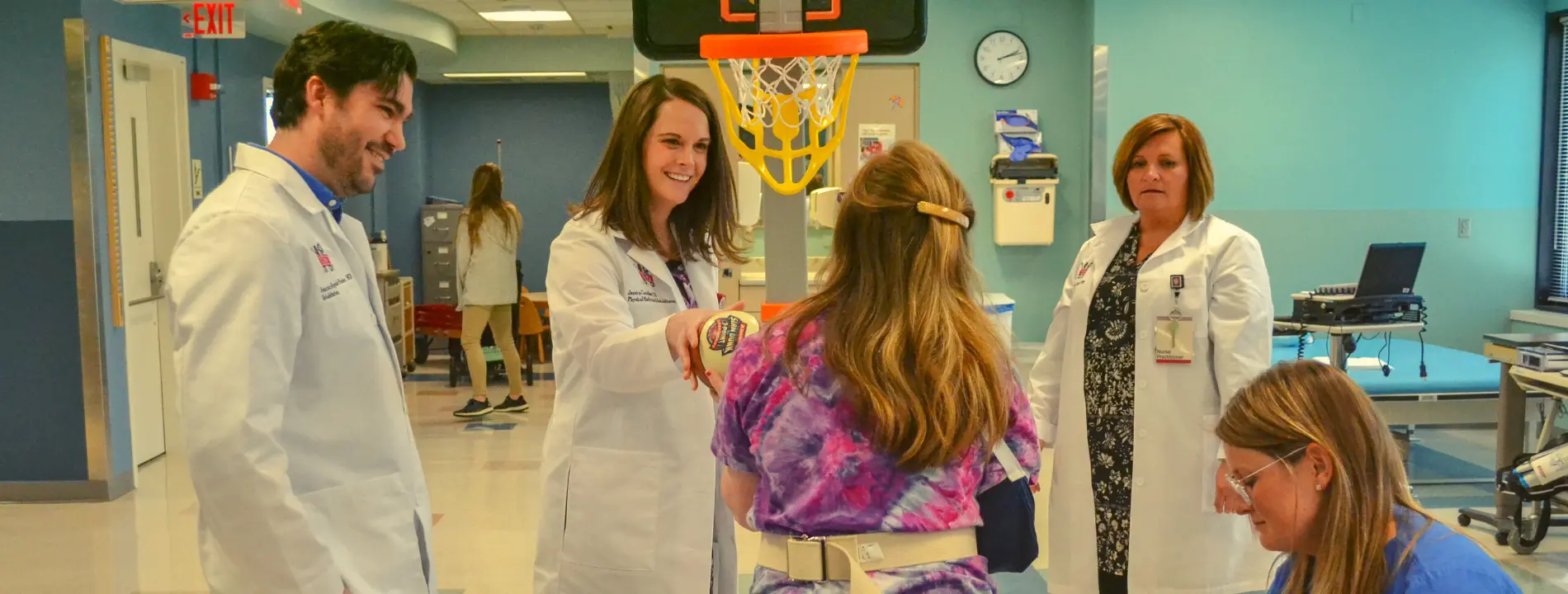 The PPMR team works with a patient in the rehabilitation gym