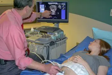 Faculty member reviews echocardiography findings with patient.  