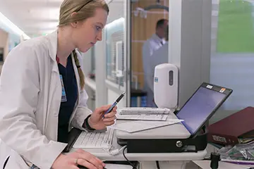 Faculty member reviews test for patient. 