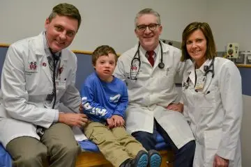 A care team and patient in a hospital room