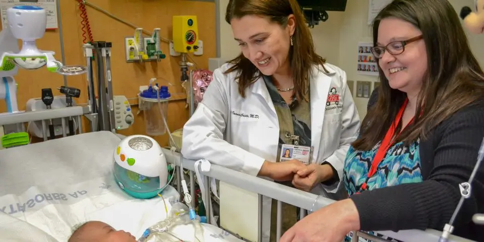 A provider and nurse taking care of a pediatric patient