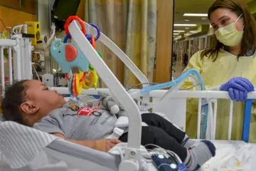 A pediatric patient and provider in a hospital