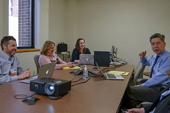 Four people discussing around a table