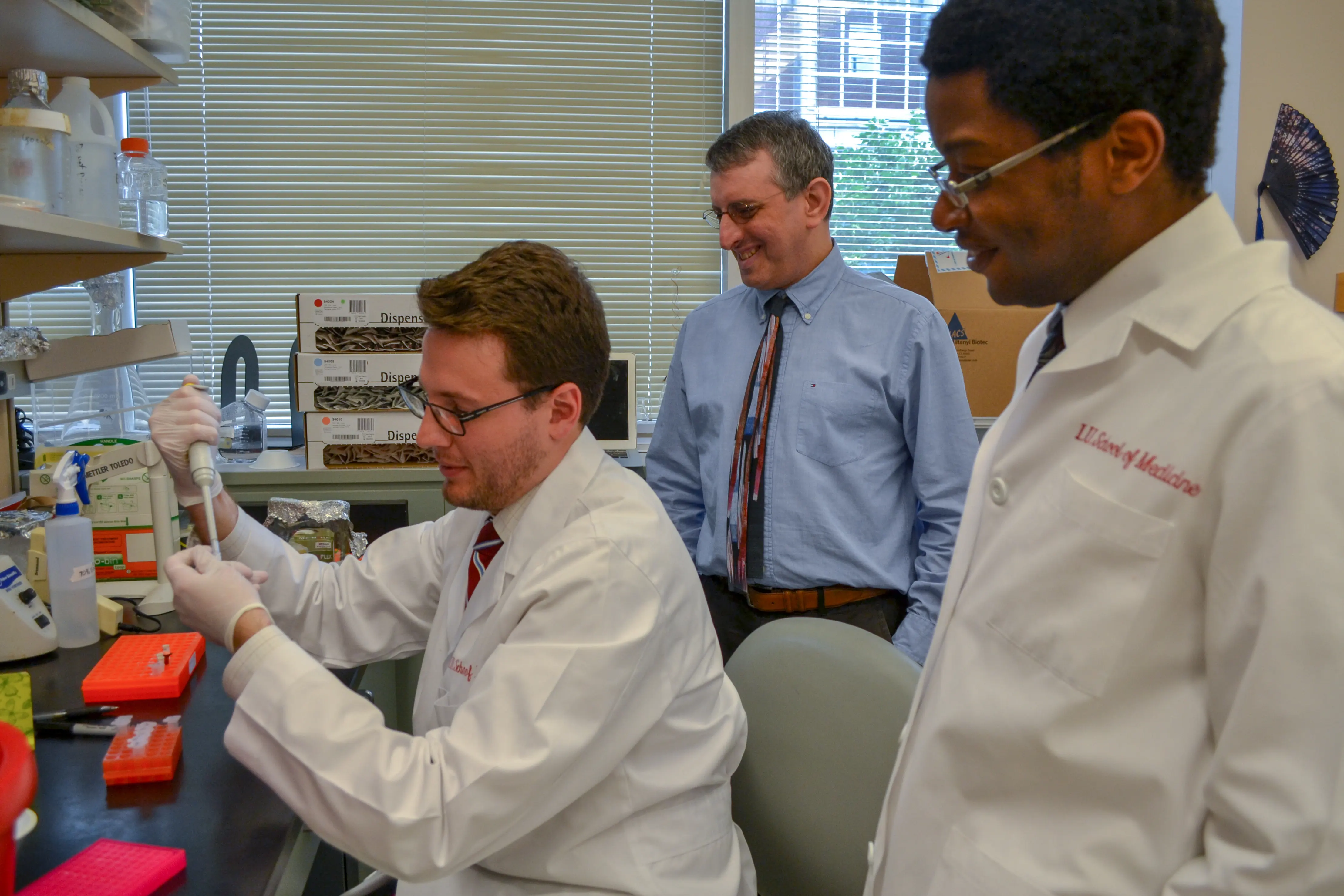 Mark Kaplan oversees lab members in the Wells Center for Pediatric Research